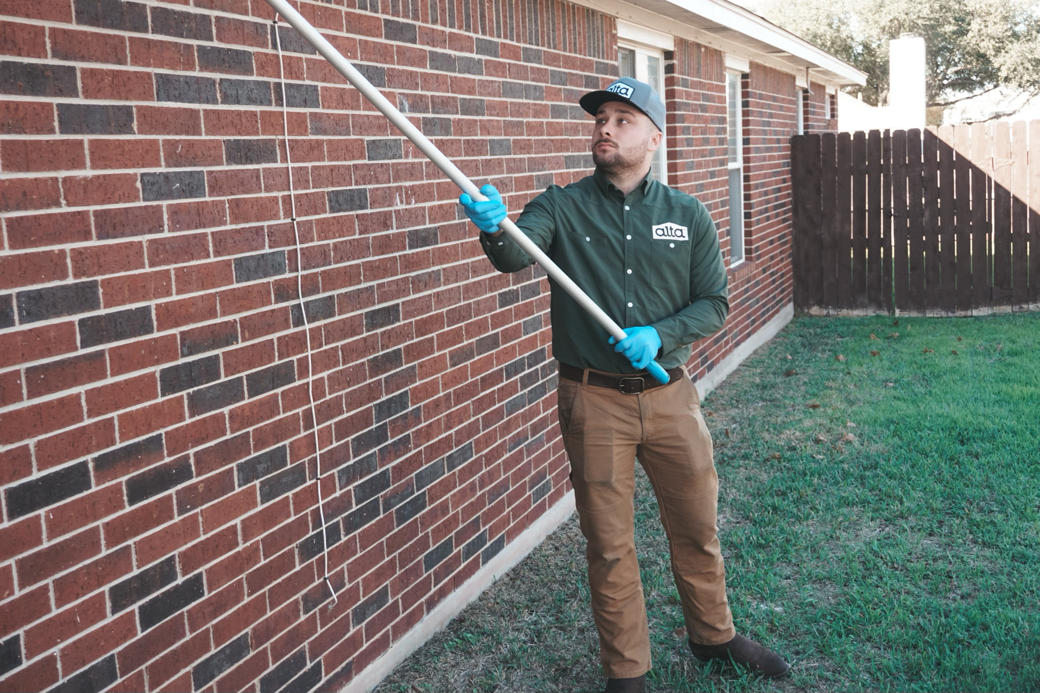 Exterminator performing wasp nest removal in Alexandria, VA