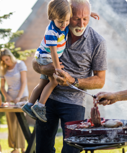 grandpa and grandson bbqing outside without mosquitoes